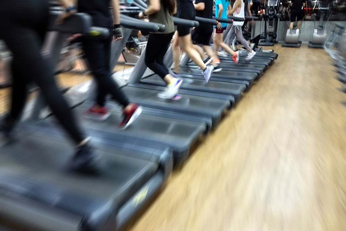 Blurred healthy cardio running people burnout fat on runway at fitness gym
